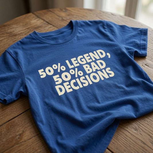 Blue 50% Legend 50% Bad Decisions slogan t-shirt on wooden table, soft light, fun dad gift tee