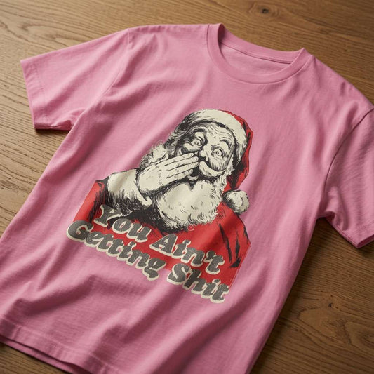 Pink You Ain’t Getting Shit Santa t-shirt on wooden table, funny rude Christmas slogan tee for her