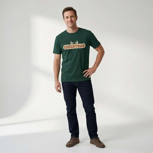 Man in green Christmas antlers t-shirt standing casually, mens christmas fun party shirt
