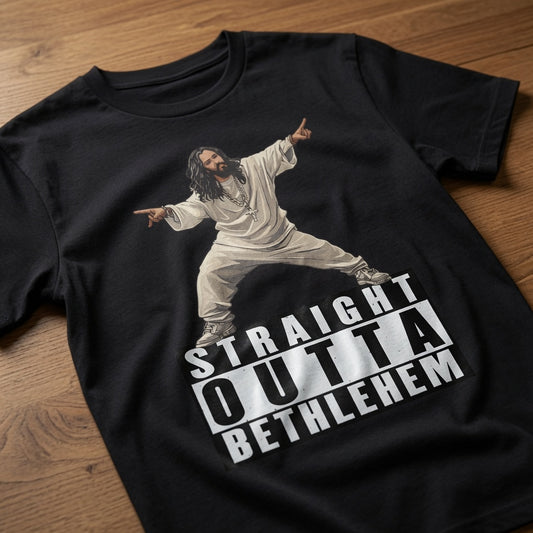 Black Straight Outta Bethlehem t-shirt laid flat on a wooden surface showing the full Jesus rapper graphic, funny mens offensive witty jesus rapper design full of pure attitude