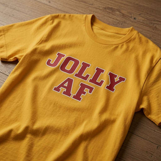 Yellow Jolly AF t-shirt laid flat on a wooden surface showing the bold red slogan, mens witty Xmas day pub banter shirt full of pure attitude