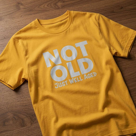Mustard yellow Not Old Just Well Aged t-shirt laid flat on a wooden surface, clean white text that makes the perfect mum or grandma gift