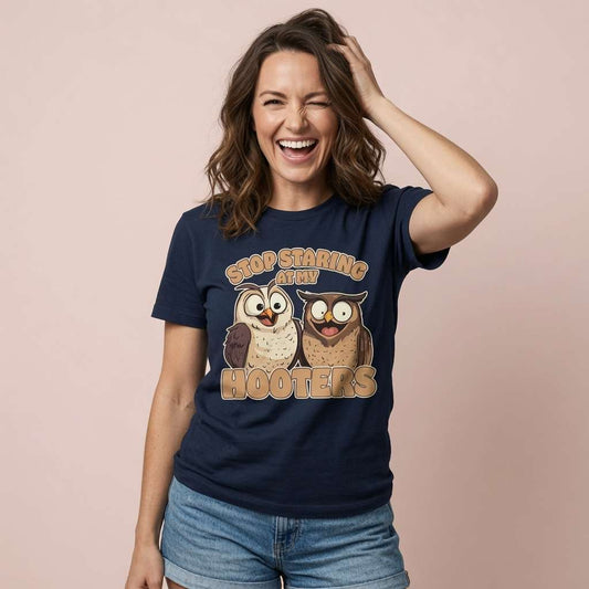 Woman laughing with one hand in her hair in a navy Stop Staring at My Hooters t-shirt, fun and cheeky ladies animal graphic that every no-nonsense lady will claim