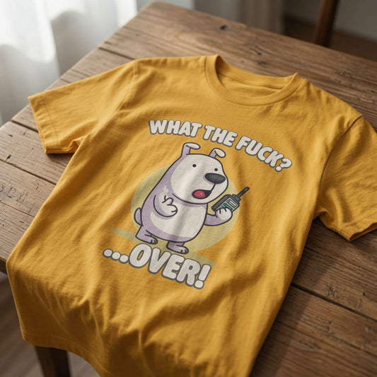 Yellow What the Fuck? …Over! t-shirt laid flat on a wooden surface featuring a cartoon dog holding a radio, fun rude offensive phonetic pup Sunday design