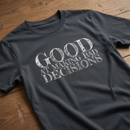 Ink grey Good at Making Bad Decisions t-shirt on wood with chalk-style text, funny relatable ladies slogan