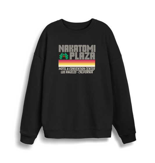 black christmas sweater with a retro design and the slogan 'nakatomi plaza hotel and convention centre'
