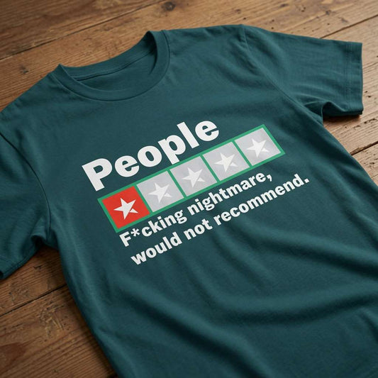 Teal green t-shirt laid flat on a wooden surface featuring a one-star review graphic with the text “People – F*cking nightmare, would not recommend”, rude review slogan design for women