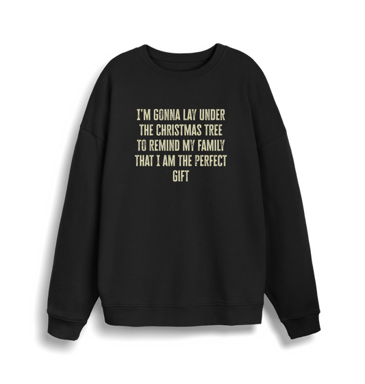 black christmas sweater with the slogan 'im gonna lay under the christmas tree to remind my family that i am the perfect gift'