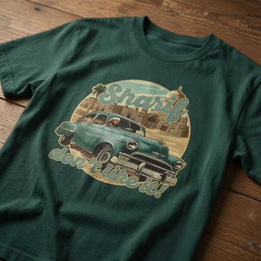 Green Sharif Don’t Like It! t-shirt laid flat on a wooden surface showing the full vintage car and city graphic, fun mens music inspired graphic design full of pure attitude