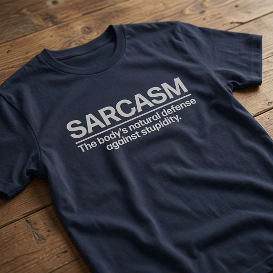 Navy Sarcasm t-shirt laid flat on a wooden surface showing the full slogan, funny ladies relatable witty slogan design full of pure attitude