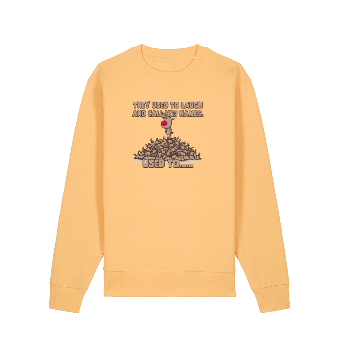 yellow christmas sweater with the graphic of rudolph stood on top of a pile of reindeer and the slogan 'they used to laugh and call him names used to... '
