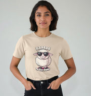 A person wearing a beige T-shirt with a cartoon sheep in sunglasses, captioned 