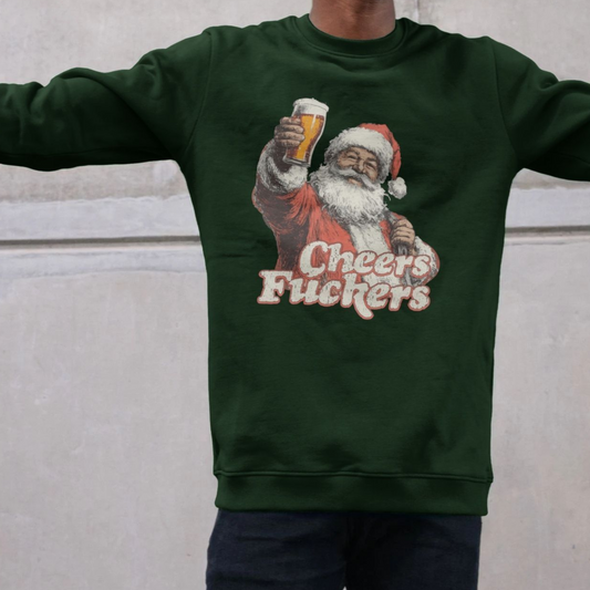 A person wearing a dark green sweatshirt featuring a vintage-style Santa holding a beer and the text "Cheers Fu**ers," conveying humor and festive irreverence.