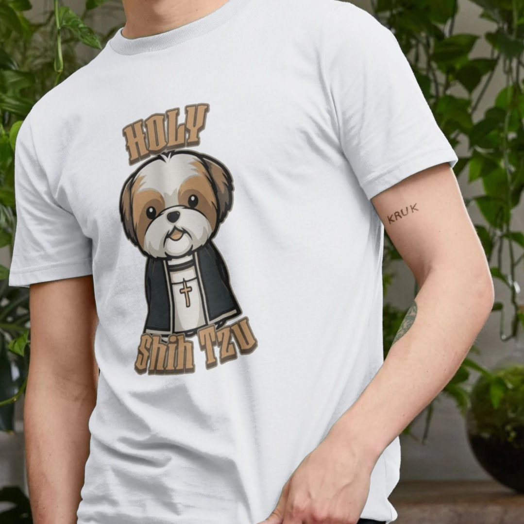 A person wearing a white Dog T-shirt with a cartoon of a Shih Tzu dressed as a priest, featuring a cross necklace and the words "Holy Shih Tzu." The background has green plants, creating a playful and humorous tone.
