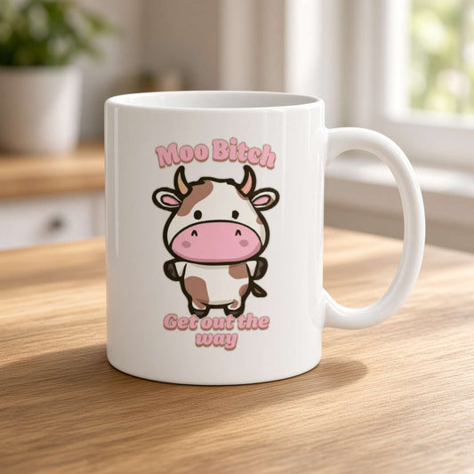 white ceramic mug with the graphic of a cow and the text 'moo bitch get out the way'