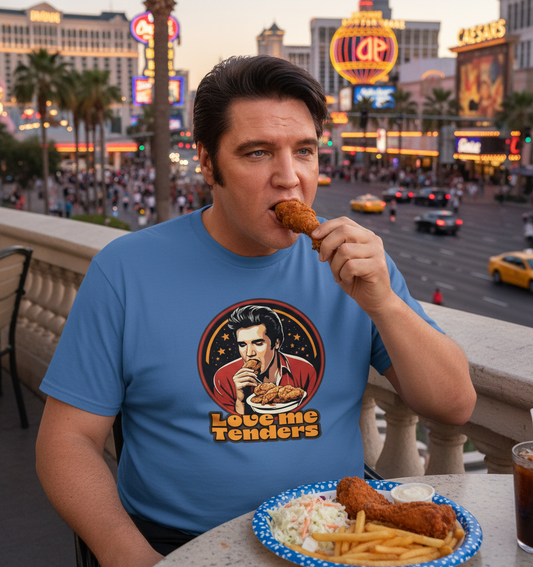 a man eating fried chicken wearing a blue funny graphic t-shirt with an Elvis design and the slogan 'love me tenders'