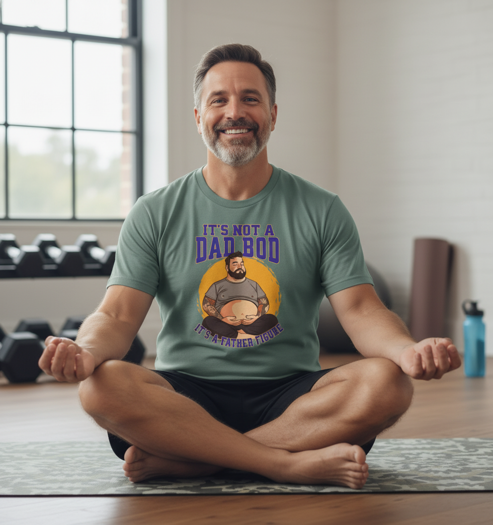 man sat in a yoga position wearing a green t-shirt with the slogan 'this is not a dad bod it's a father figure'