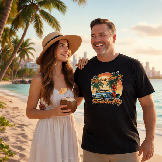 man and woman on a beach, man is wearing a black music inspired t-shirt with a GTA style graphic and the slogan 'paradise city'