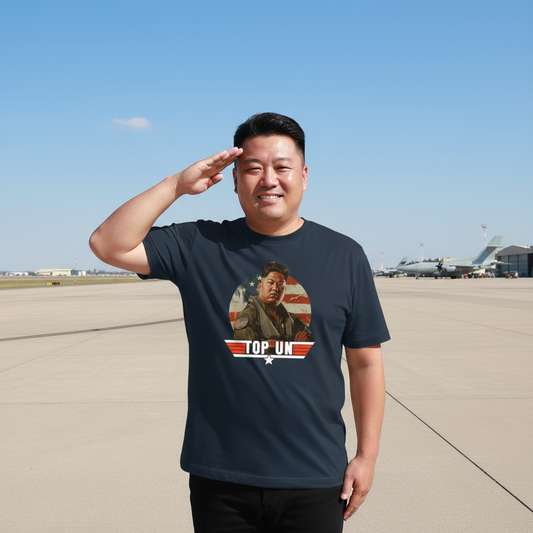 Man wearing a navy graphic t-shirt with the image of kim jong un and the slogan 'top un'