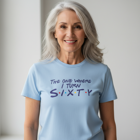 woman wearing a light blue slogan t-shirt with the text 'the one where i turn sixty'