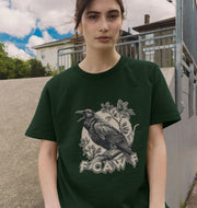 A person wearing a dark green T-shirt with a graphic of a crow perched on a branch with leaves. 
