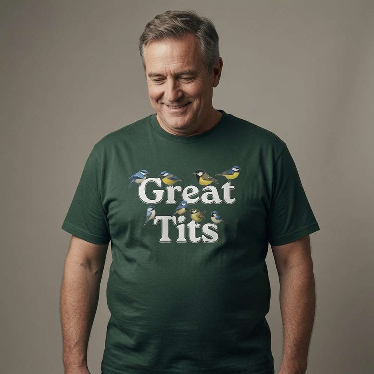Grey-haired man smiling looking down in glazed green Great Tits t-shirt, funny witty offensive bird pun graphic