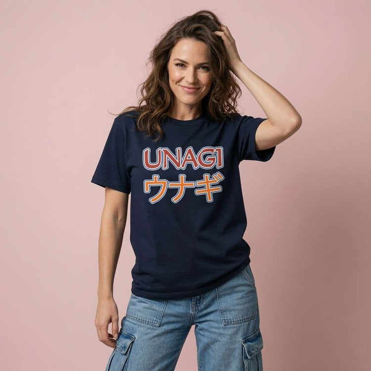 Woman smiling with one hand in her hair while wearing a navy Unagi t-shirt featuring English and Japanese text, witty total state of awareness eel ladies design