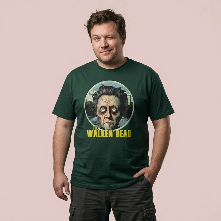 Man winking with one hand in his pocket while wearing a green The Walken Dead t-shirt, mens fun zombie walker pun design full of pure attitude