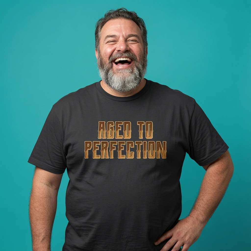 Man laughing with one hand on his hip while wearing a black Aged To Perfection t-shirt, fun mens witty grandad gift design full of pure attitude