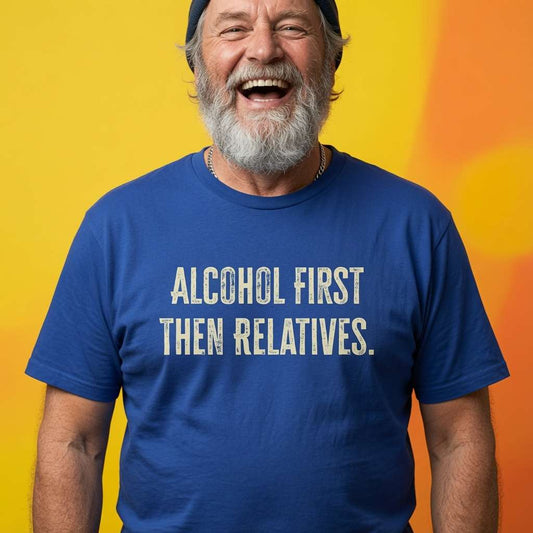 Older bearded man laughing while wearing a blue Alcohol First Then Relatives t-shirt, funny mens witty Xmas day slogan design full of pure attitude that every cheeky lad will claim