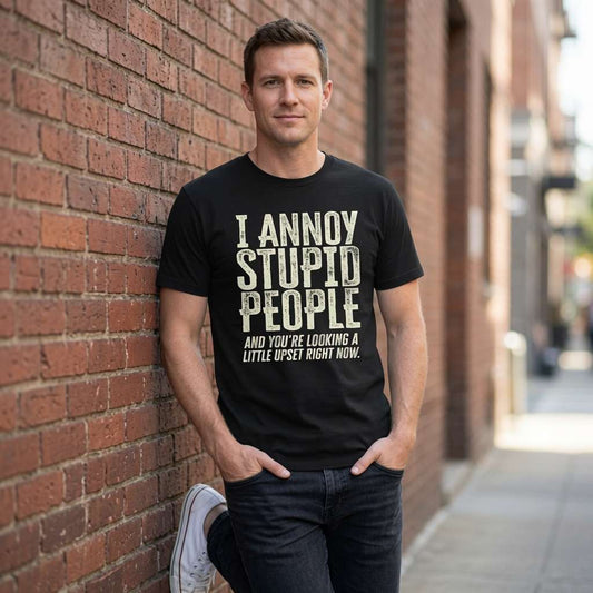 Man in black I Annoy Stupid People tee against brick wall, funny witty sarcastic mens gift