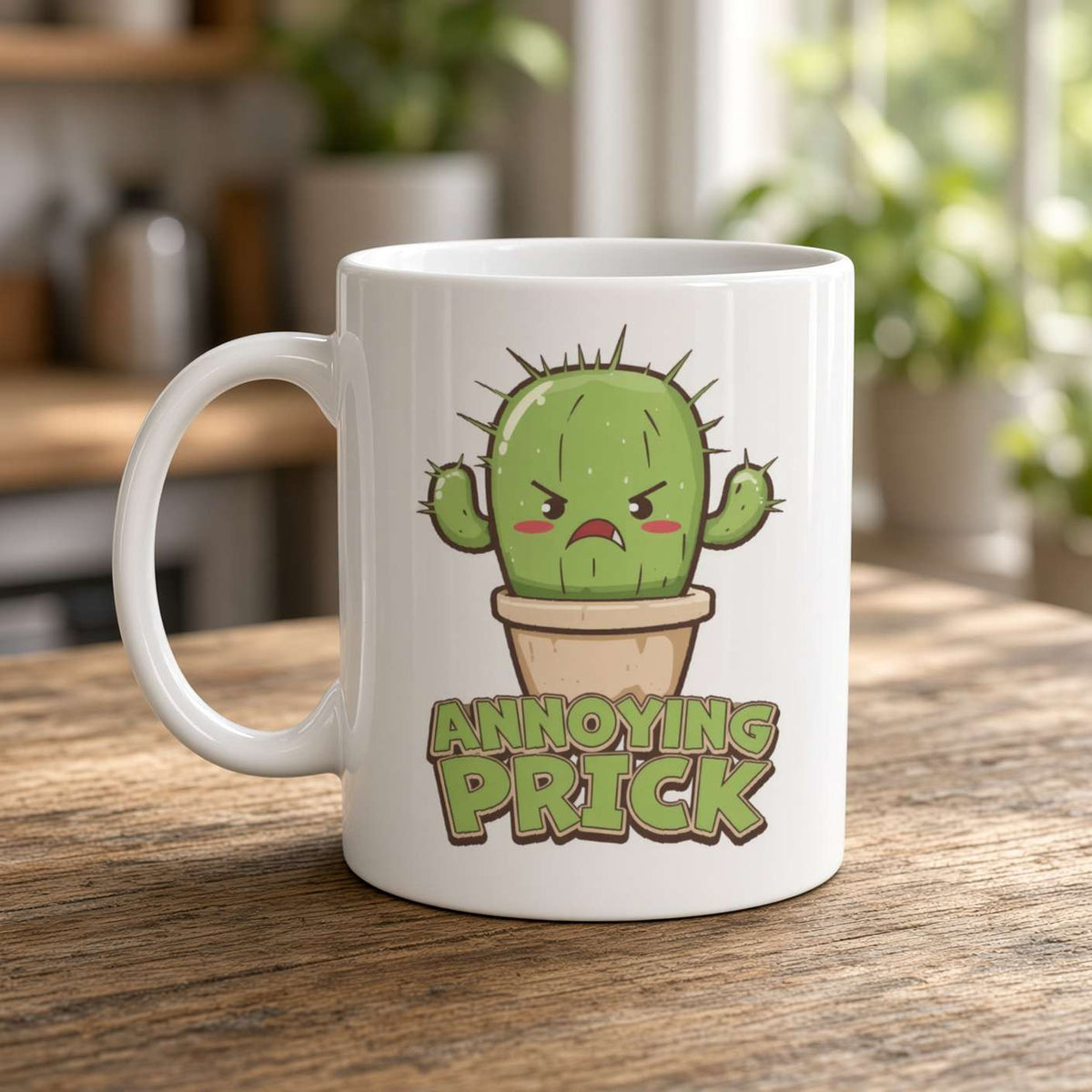 A white ceramic mug on a wooden table features an angry cartoon cactus in a pot and the bold words “ANNOYING PRICK,” in a playful, cheeky kitchen scene.