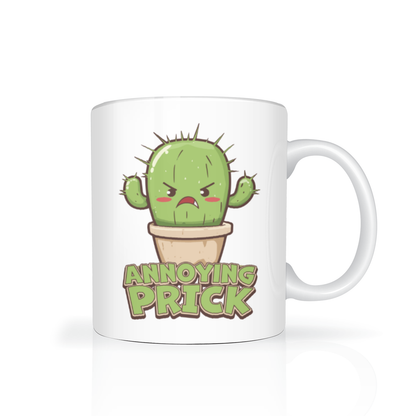 A white ceramic mug features an angry cartoon cactus in a flowerpot above the words “ANNOYING PRICK,” giving the design a playful, sarcastic tone.