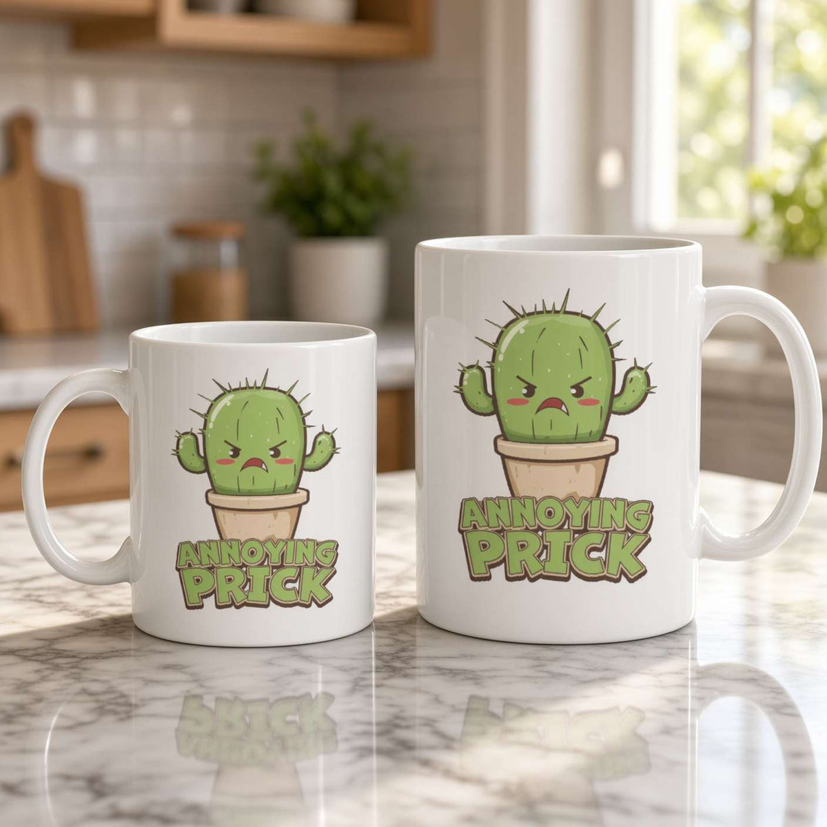 Two white mugs of different sizes on a bright kitchen counter feature an angry cartoon cactus and the words “Annoying Prick,” creating a cheeky, humorous tone.