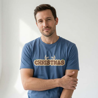 Man in blue Christmas antlers tee with arms crossed, fun xmas day slogan gift