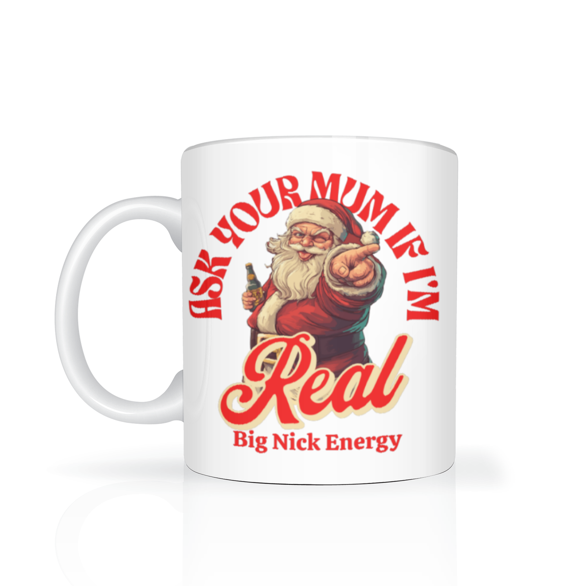 White mug featuring a retro Santa pointing at the viewer, with red text reading “Ask your mum if I’m real” and “Big Nick Energy”; playful, cheeky holiday tone.