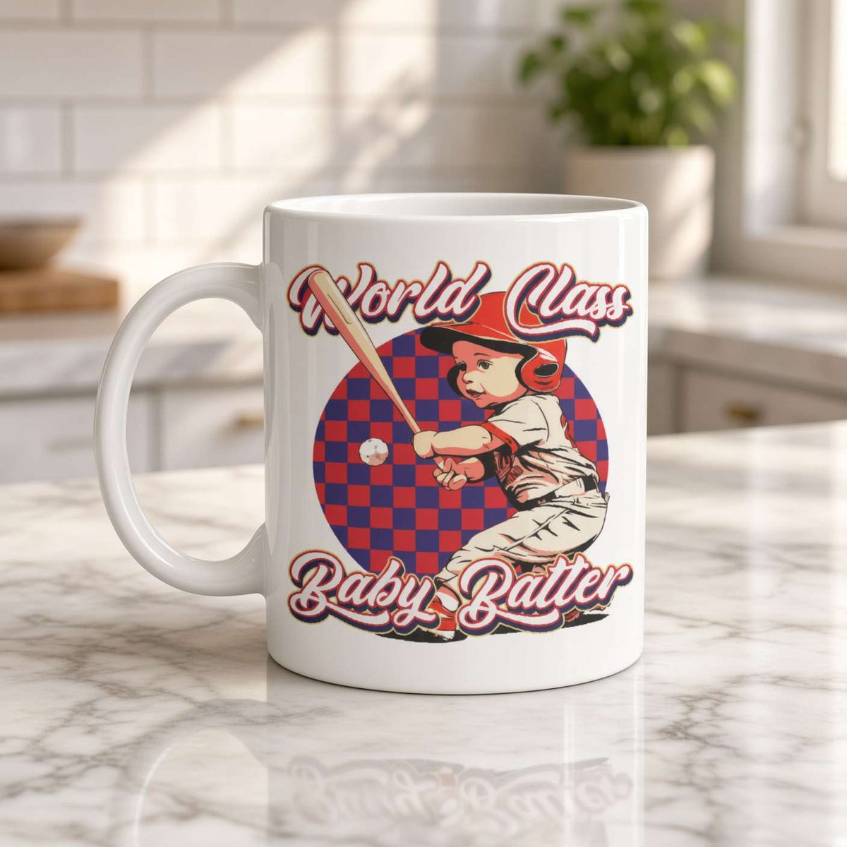 White mug on a wooden kitchen counter features a vintage red-and-blue baseball design: a helmeted batter swings beneath “World Class Baby Batter,” creating a playful, nostalgic tone.