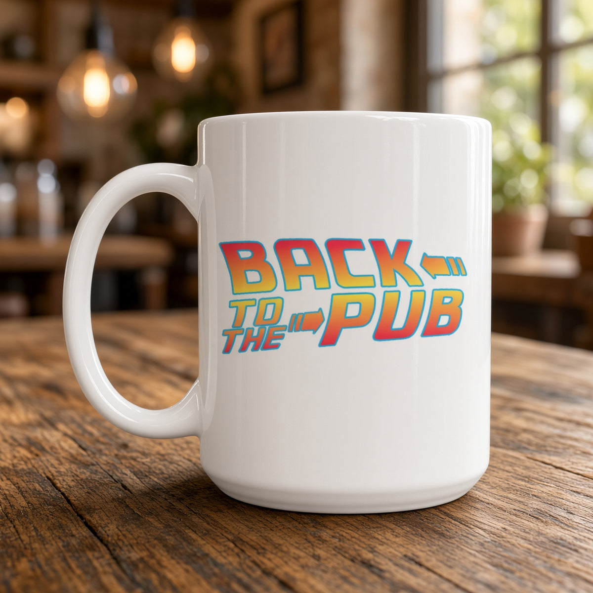 A white ceramic coffee mug with a colorful retro-style 'Back to the Pub' graphic, sitting on a rustic wooden table with a blurred cafe interior in the background.