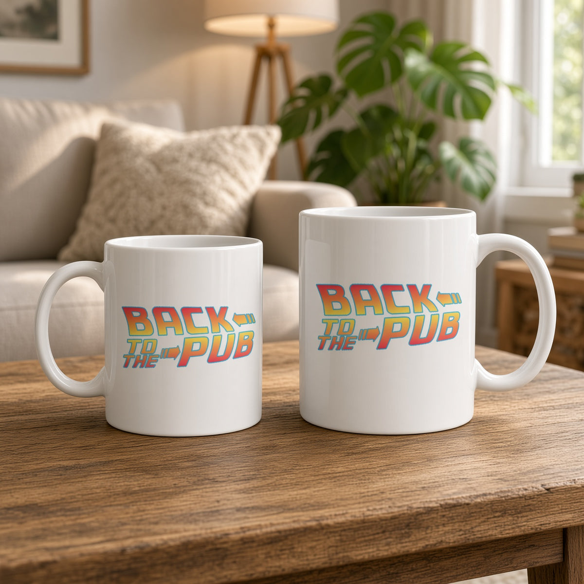 11oz and 15oz white ceramic mugs on a wooden coffee table with retro orange-to-yellow “BACK TO THE PUB” lettering and blue arrows, in a bright living room.