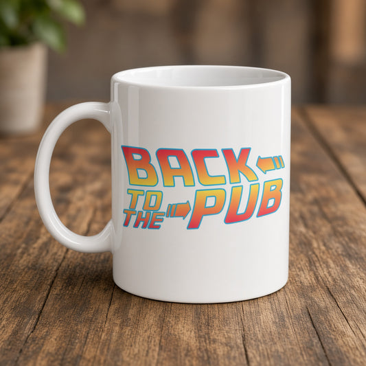 A white ceramic coffee mug with a colorful retro-style graphic reading 'BACK TO THE PUB' in red, orange, and yellow gradient lettering, set on a rustic wooden table.