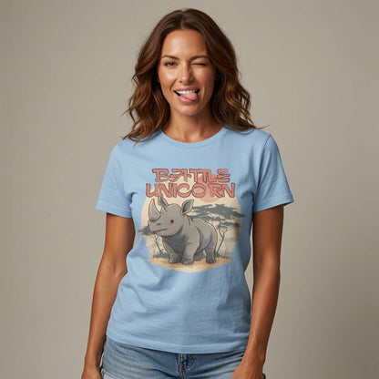 Woman in sky blue Battle Unicorn rhino t-shirt sticking tongue out, funny rhino witty pun graphic tee