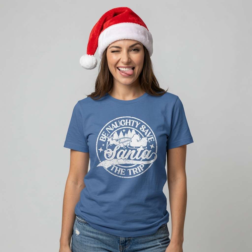 Woman in bright blue Be Naughty Save Santa The Trip tee wearing Santa hat, funny cheeky xmas slogan gift