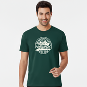 Smiling man in a dark green funny Santa T-shirt with a festive print that reads, 