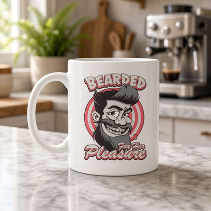 White ceramic mug on a marble kitchen counter, printed with a grinning bearded man and the words “Bearded for Her Pleasure”; coffee maker and plant in the background.
