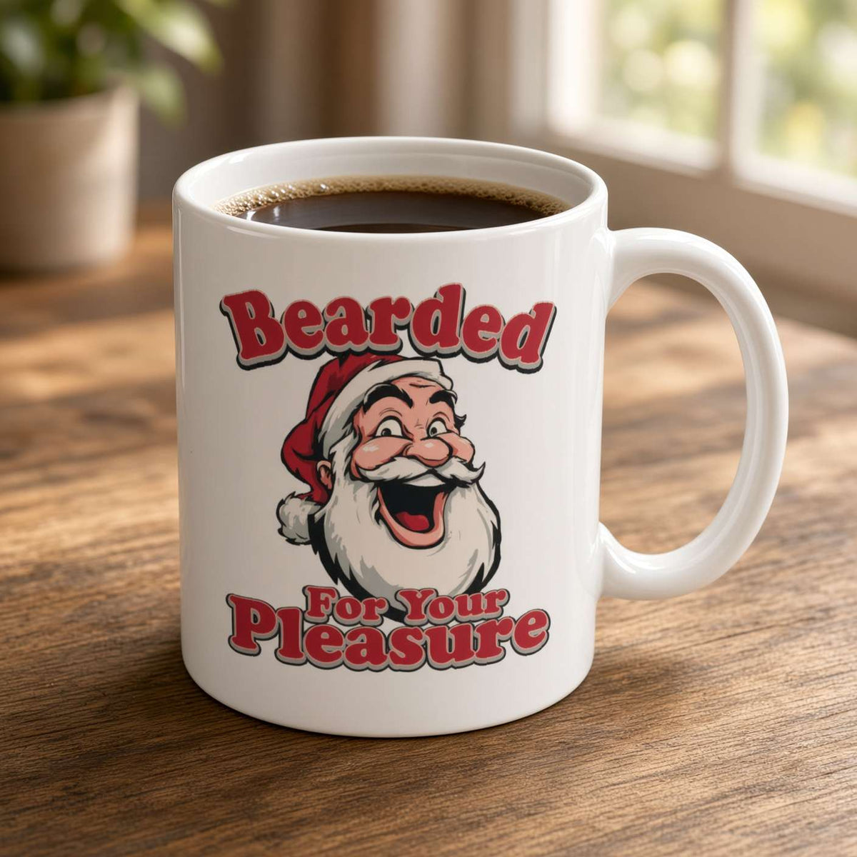 A white ceramic coffee mug filled with black coffee sits on a wooden table. The mug features a cartoon illustration of a smiling bearded man in a Santa hat with the text 'Bearded For Your Pleasure' in red and white lettering.