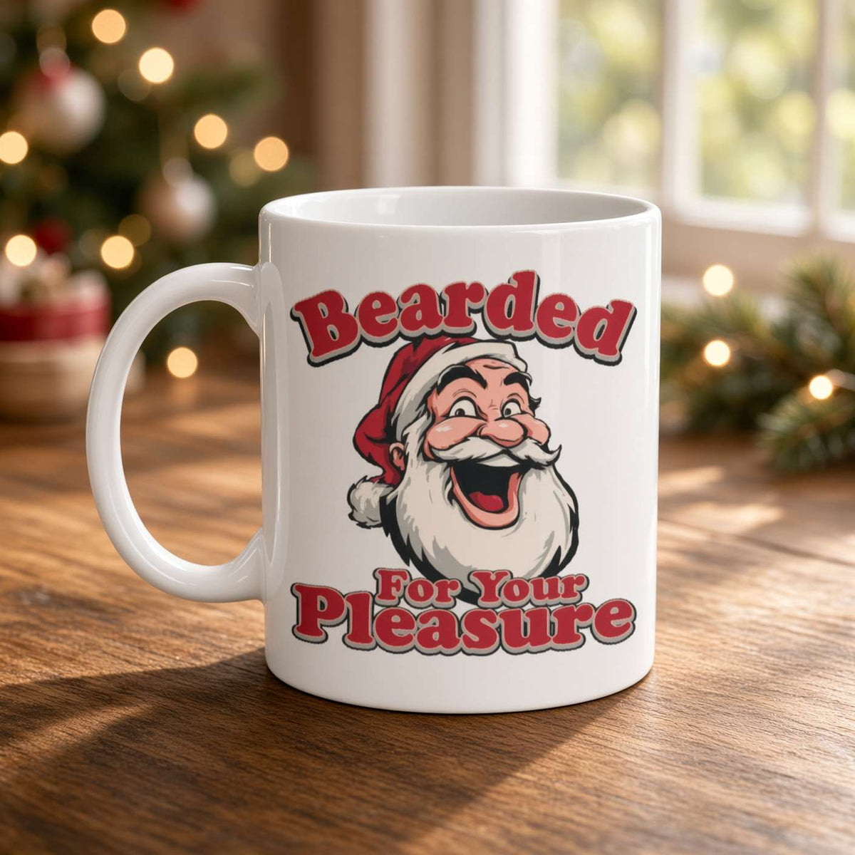 A white ceramic mug with a humorous Christmas graphic featuring a bearded Santa and the text 'Bearded For Your Pleasure' in red and black lettering. The mug is set on a wooden table with a blurred background of a Christmas tree and window.