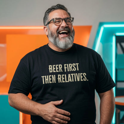 Man laughing with one hand on his stomach while wearing a black Beer First Then Relatives t-shirt, funny mens witty christmas day beer slogan design full of pure attitude