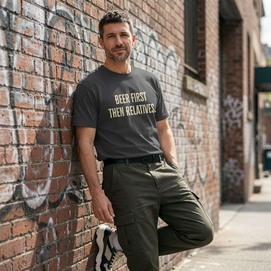 Man in dark grey Beer First Then Relatives tee against brick wall, funny sarcastic christmas day pub banter shirt