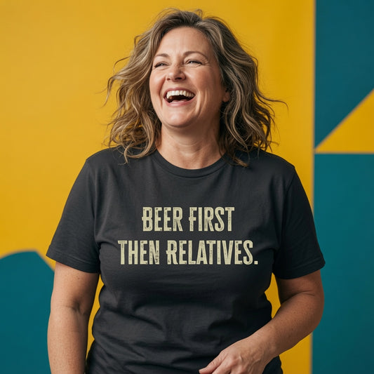 Woman laughing while wearing a black Beer First Then Relatives t-shirt, funny relatable xmas pub banter design full of pure attitude