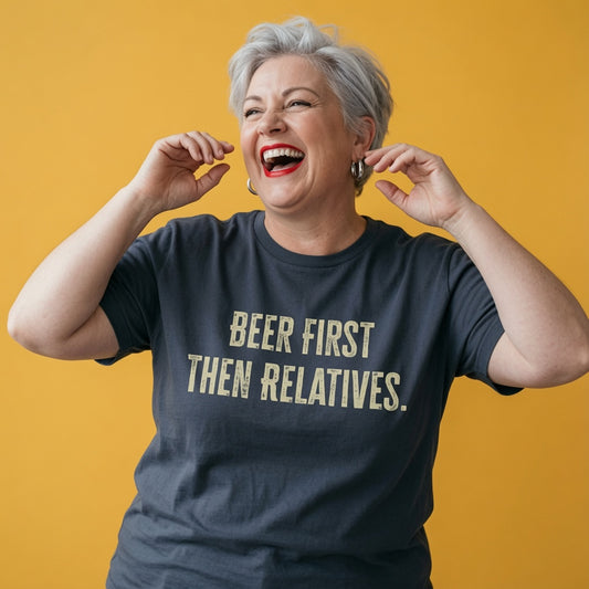 Woman laughing with both hands near her face while wearing an ink grey Beer First Then Relatives t-shirt, ladies relatable xmas party banter design that every no-nonsense lady will claim